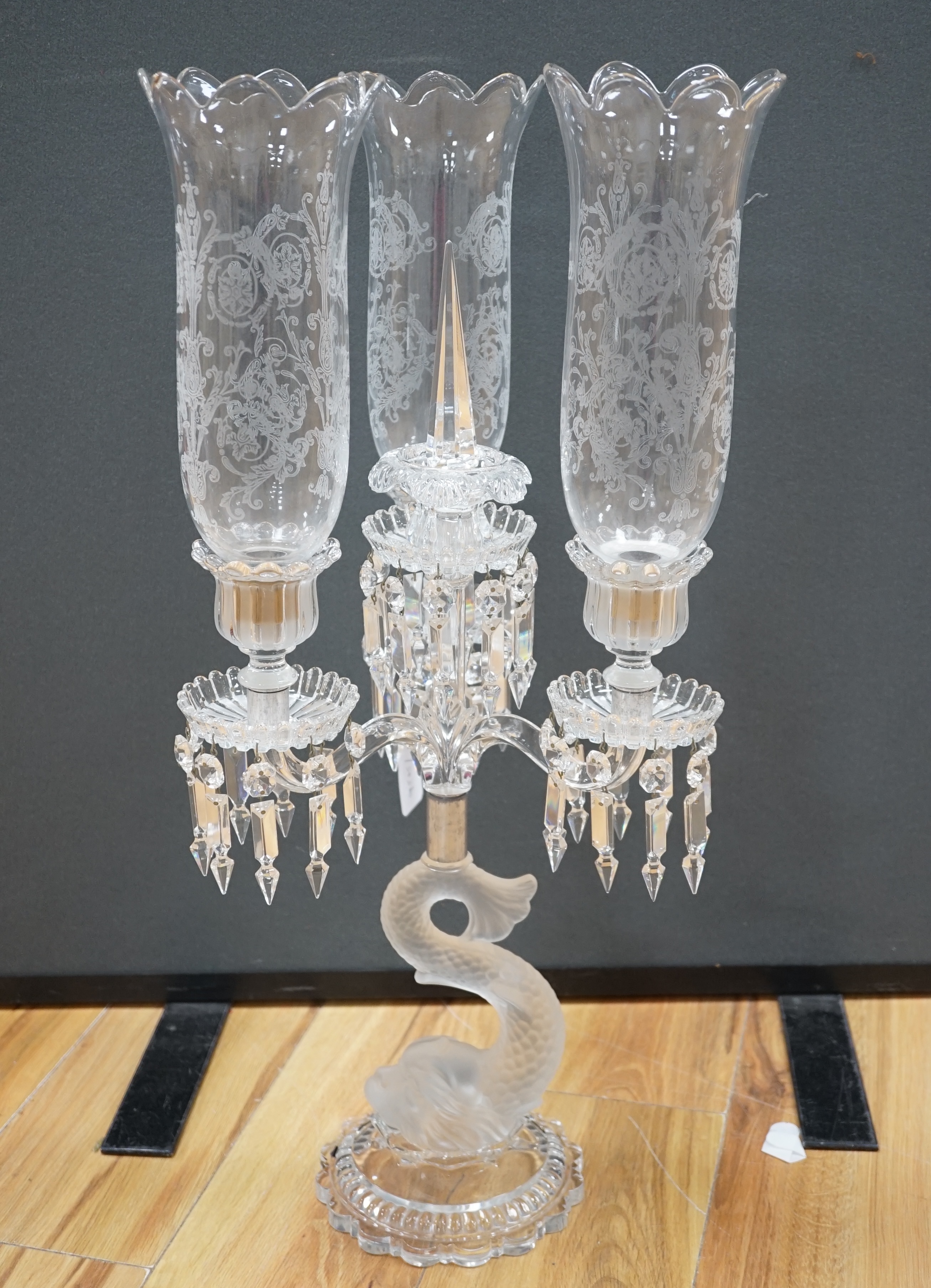 A Baccarat three branch, fish stemmed glass candelabra, 68cm high